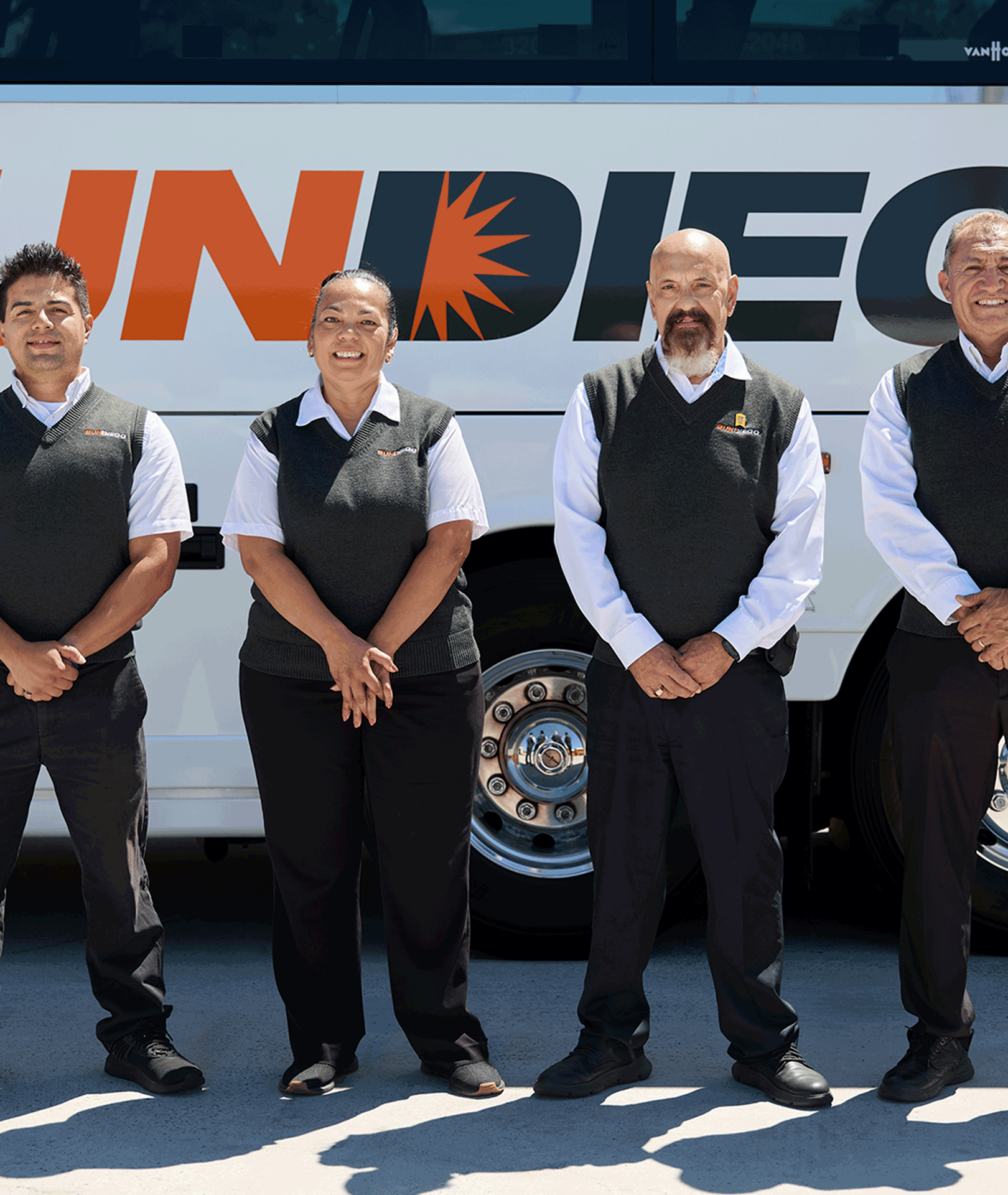 Uniformed Sun Diego Charter team members standing beside a motorcoach