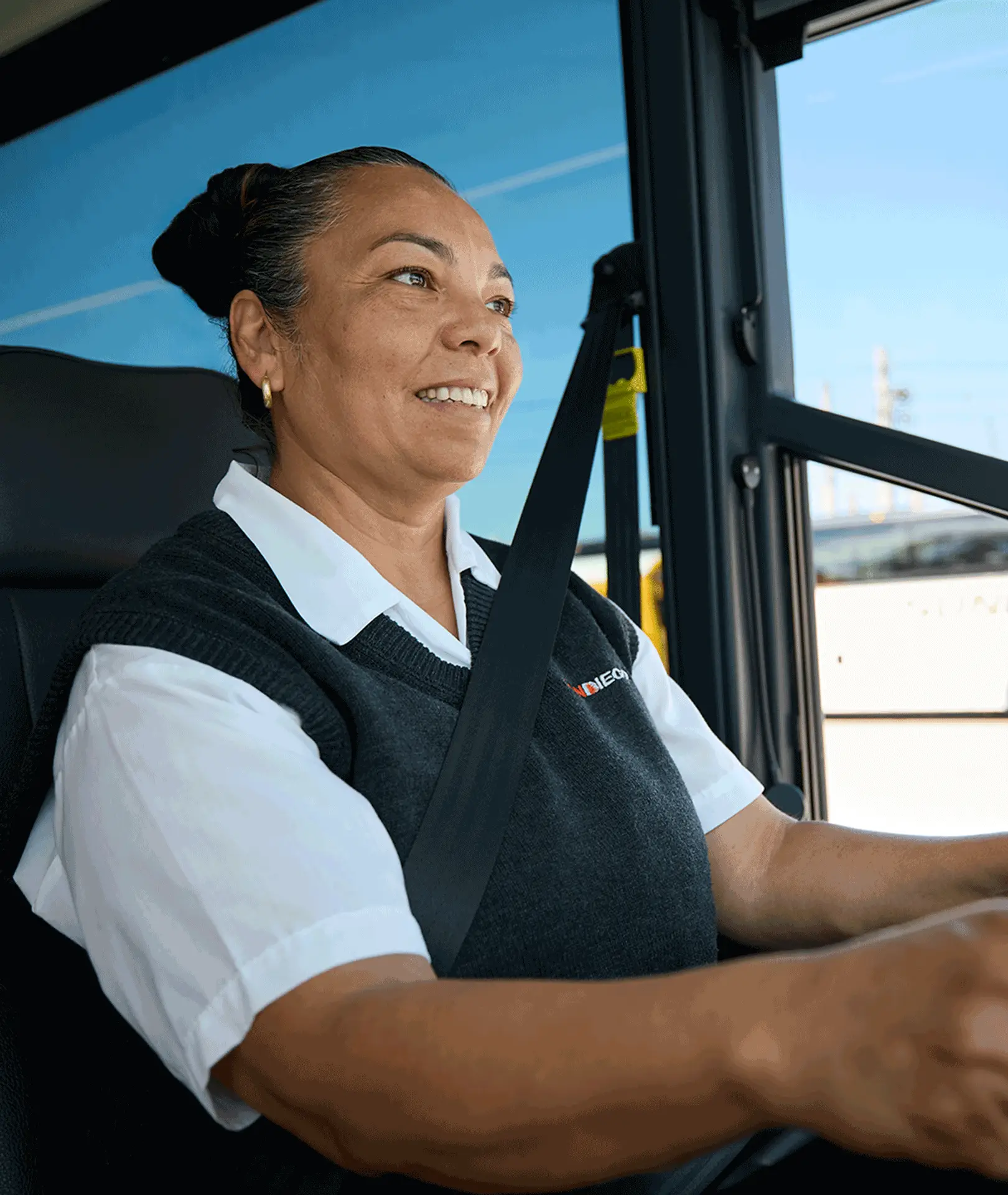 Smiling Sun Diego Charter driver seated at the wheel