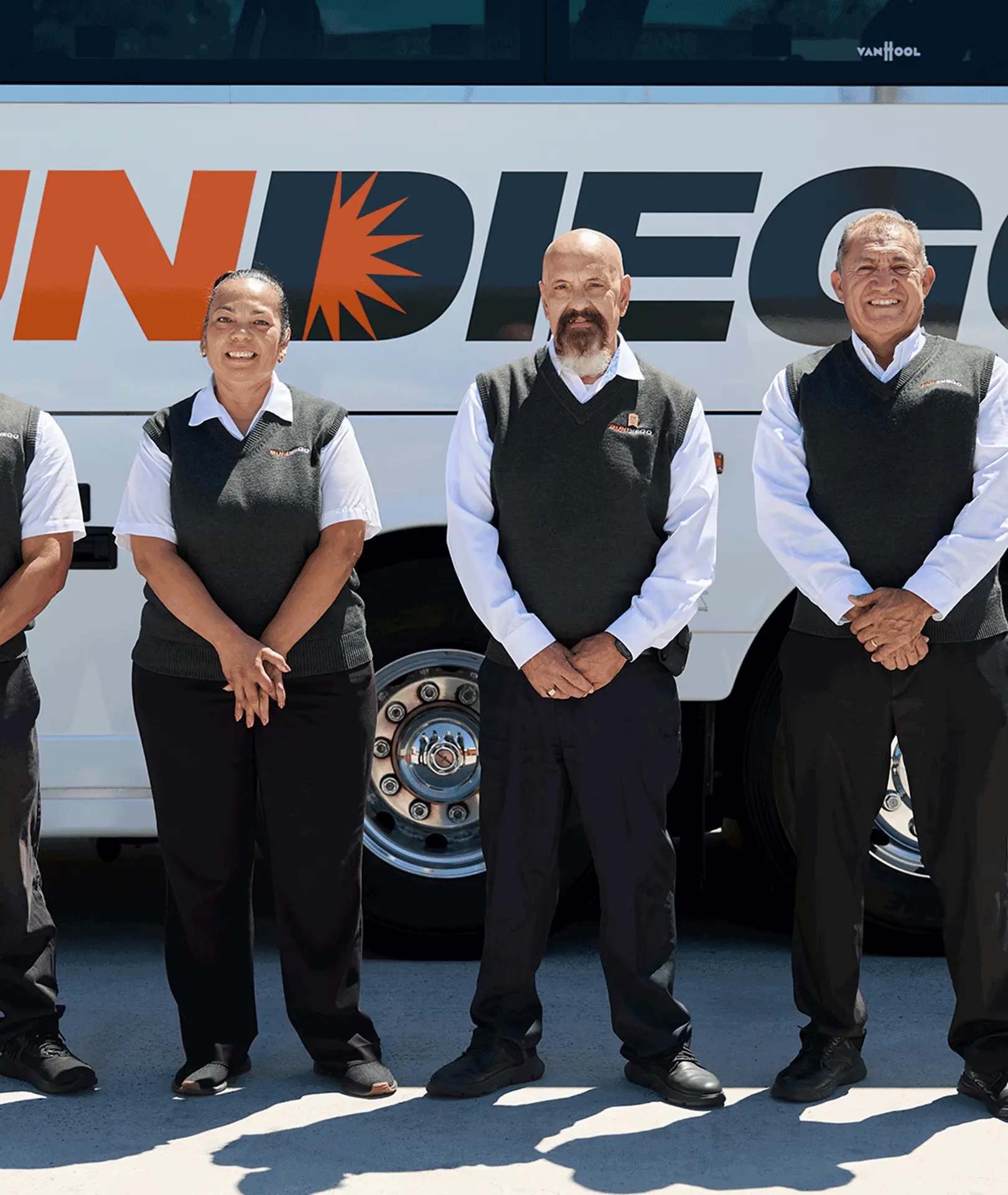Uniformed Sun Diego Charter team members standing beside a motorcoach