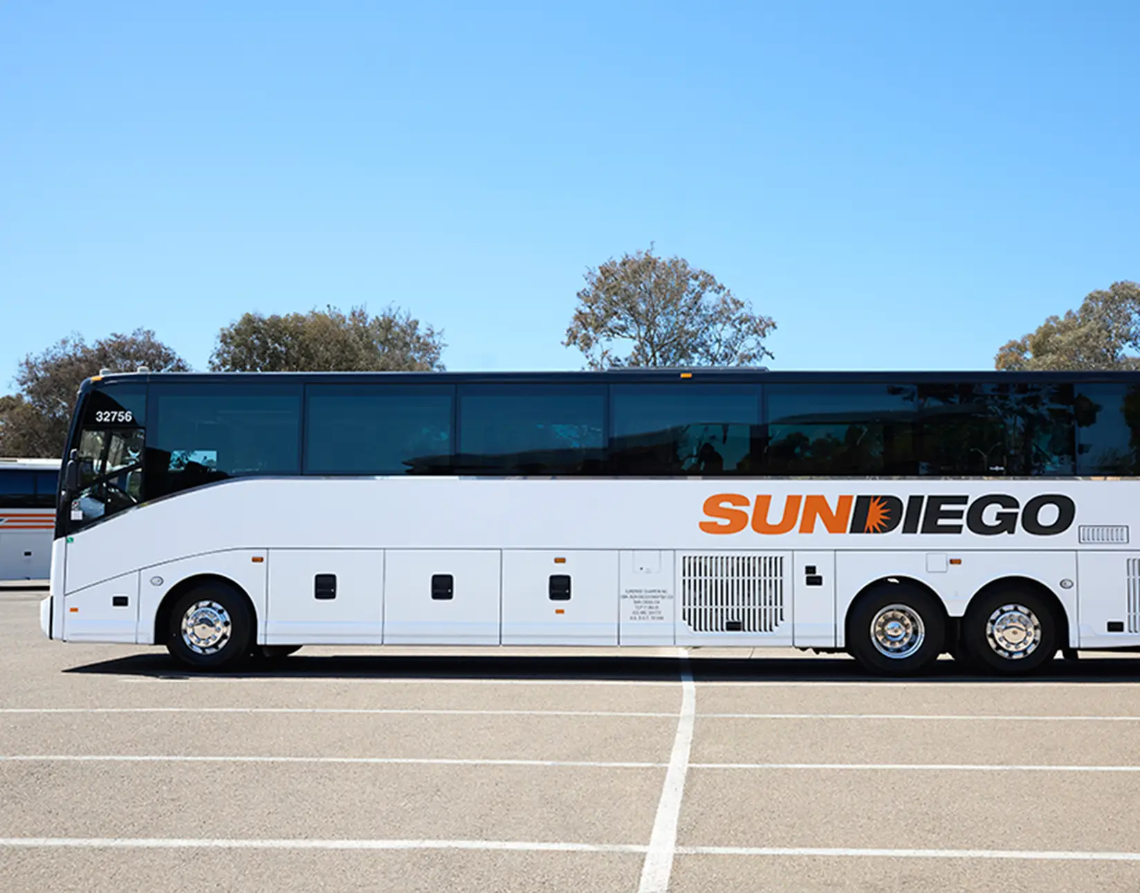 Side view of a white Sun Diego Charter motorcoach