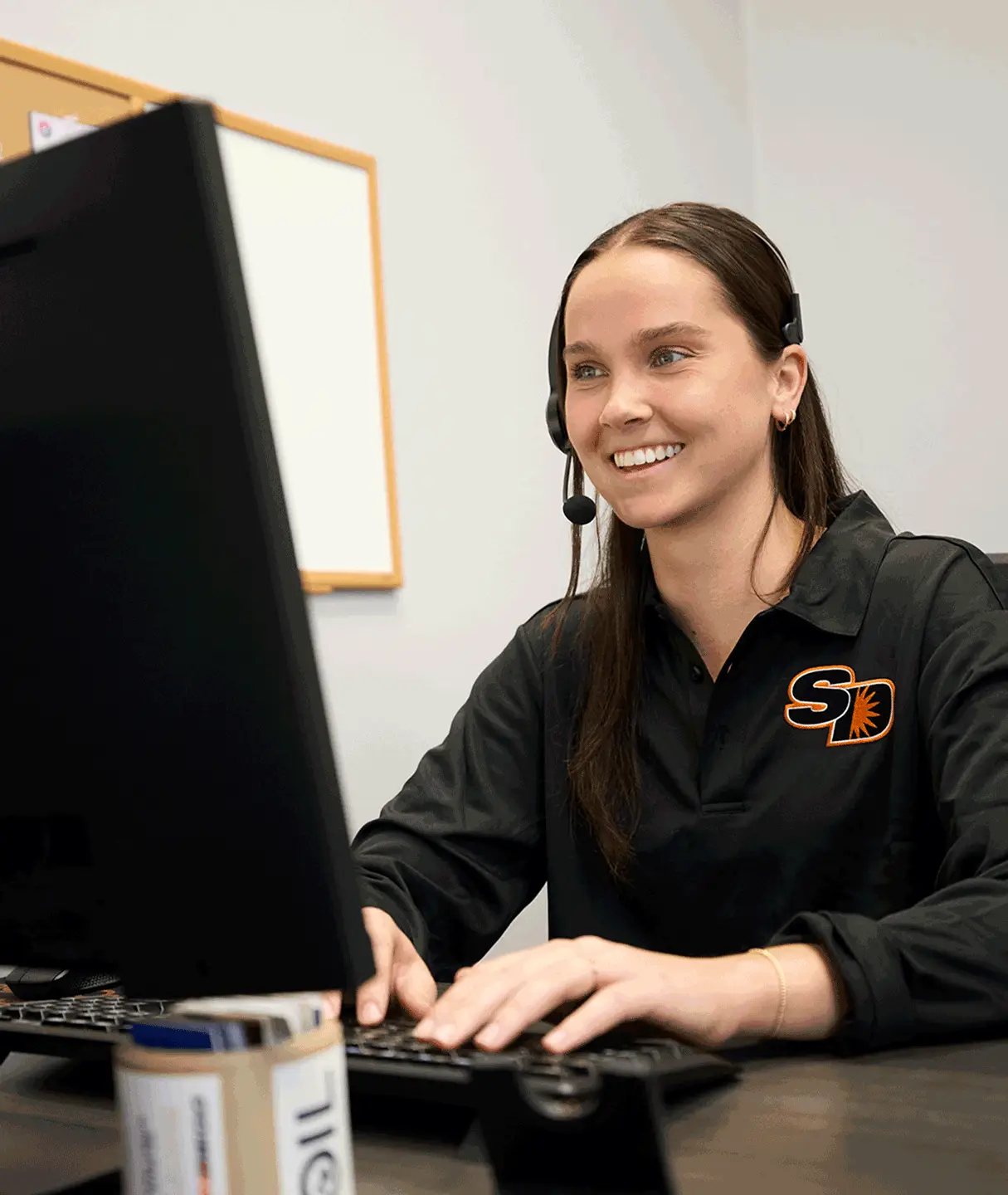 Sun Diego Charter team member wearing a headset at a computer