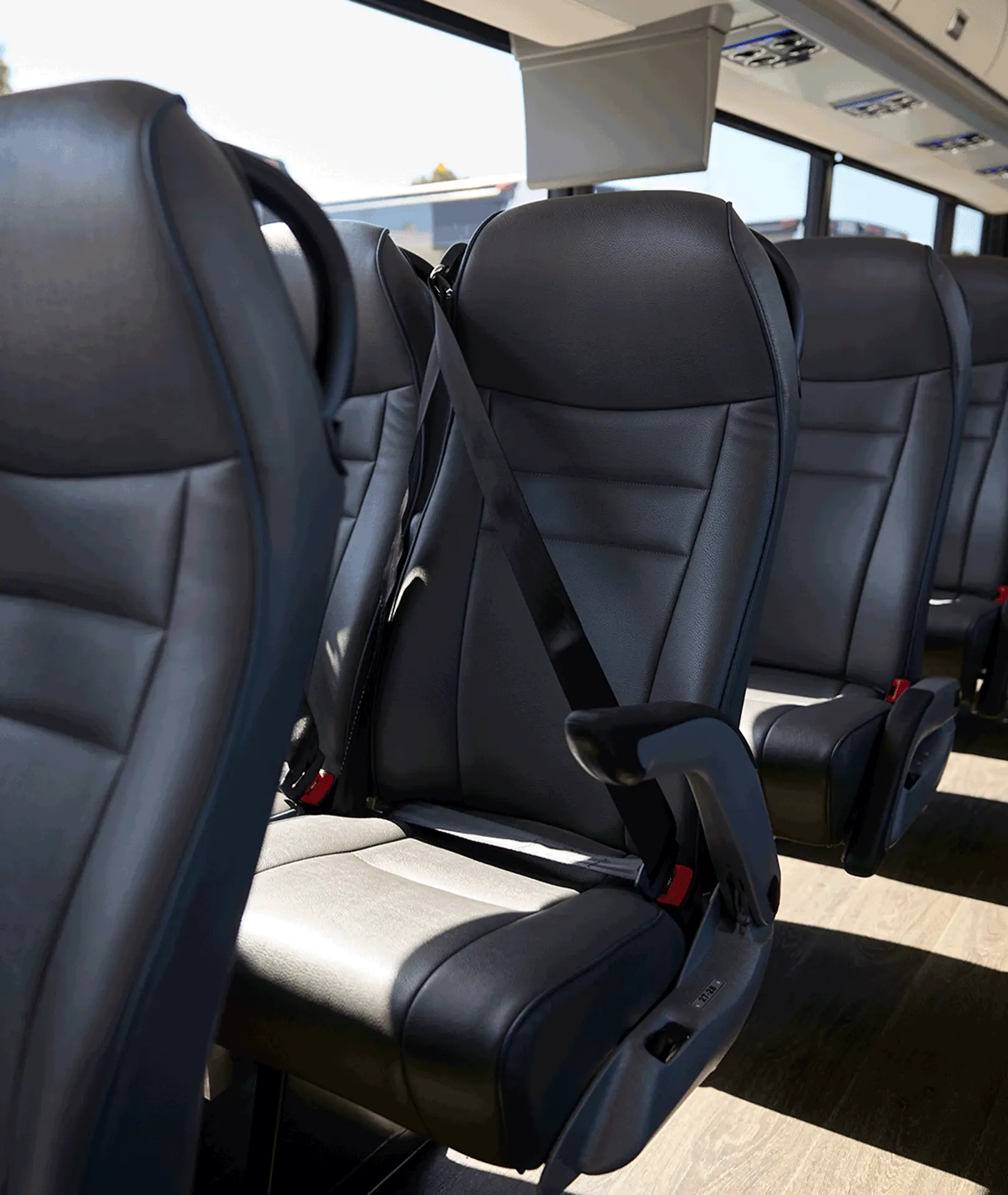 Black motorcoach passenger seat with a shoulder belt