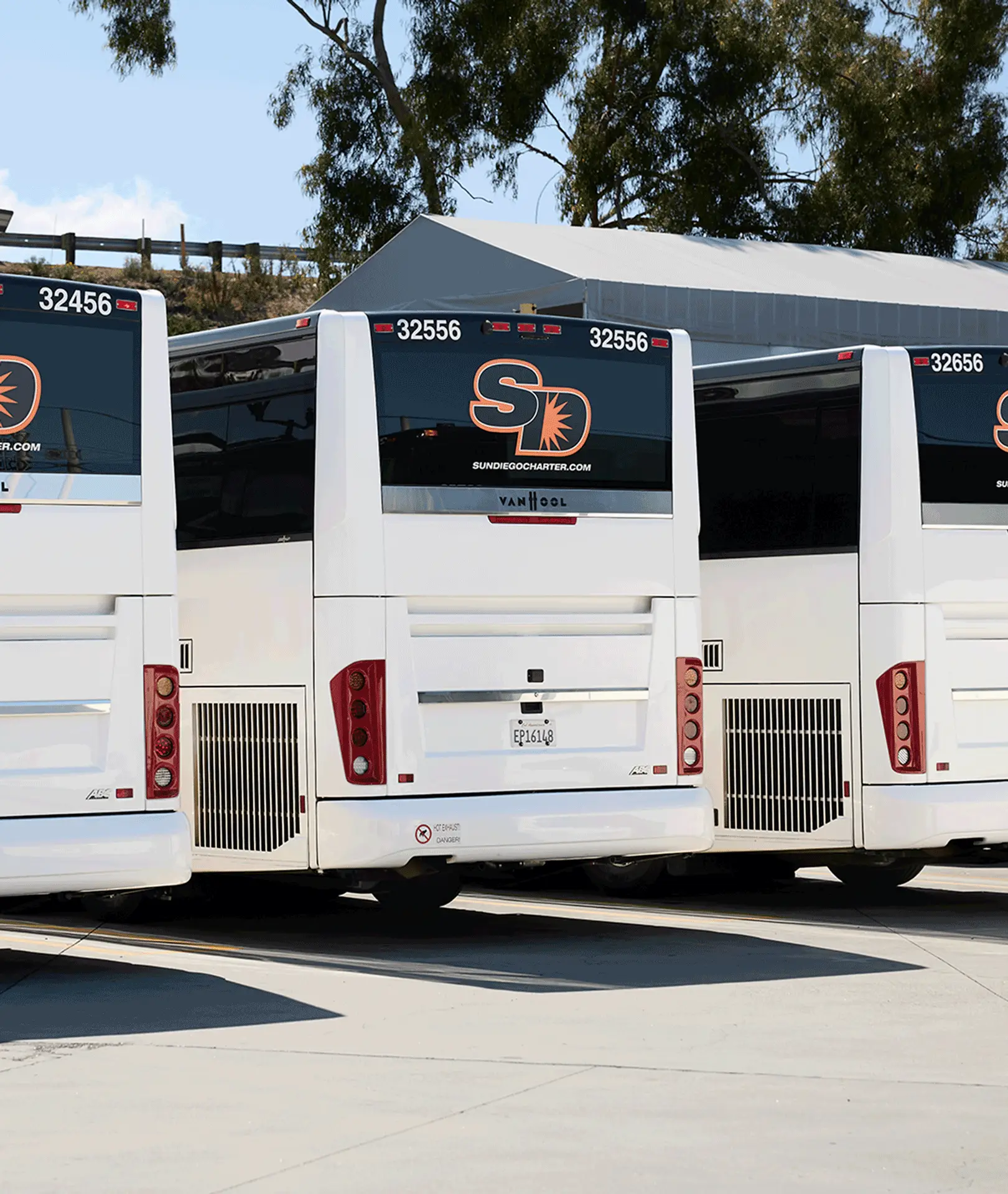 Rear view of parked Sun Diego Charter motorcoaches