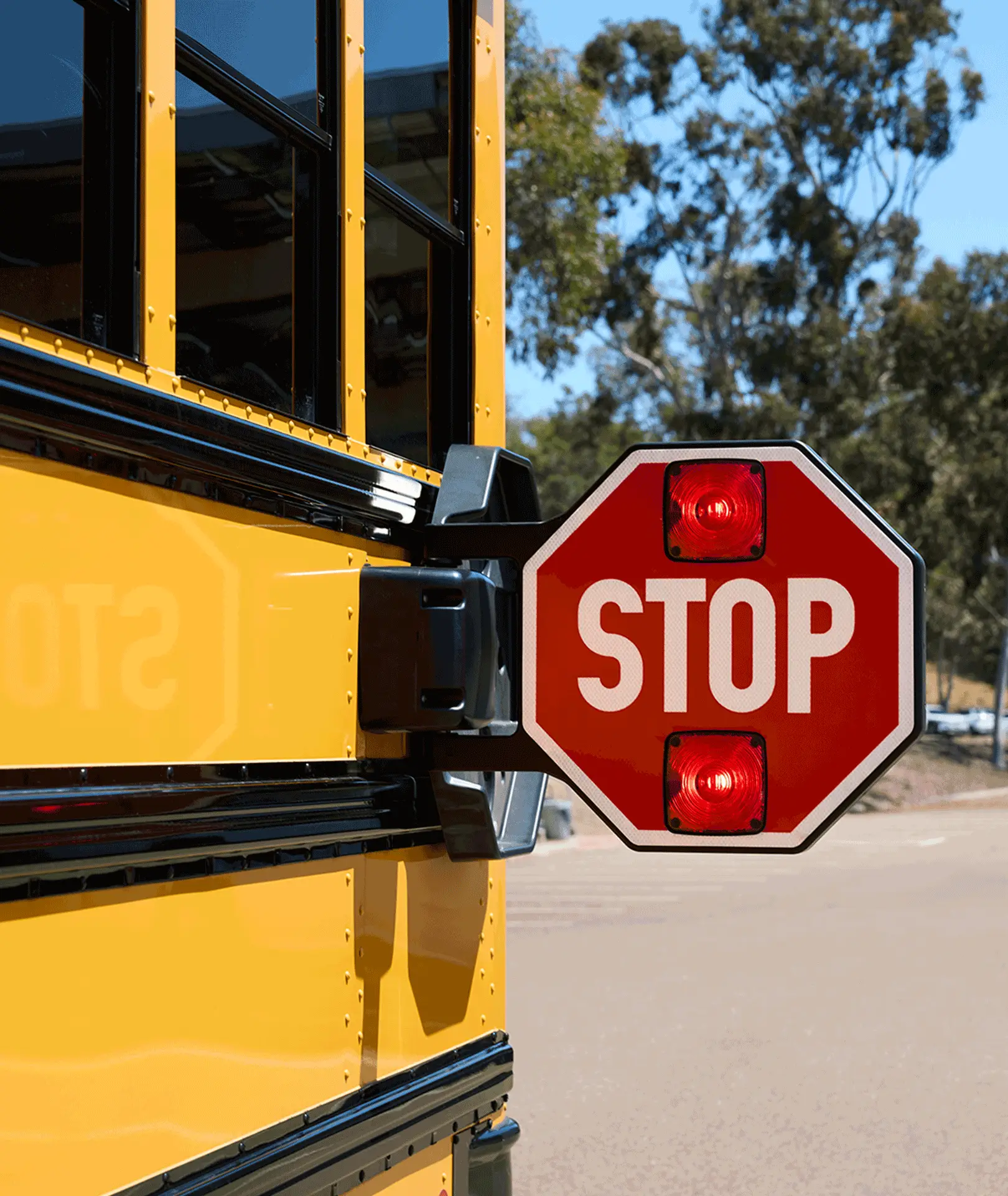 Extended stop sign on a yellow school bus