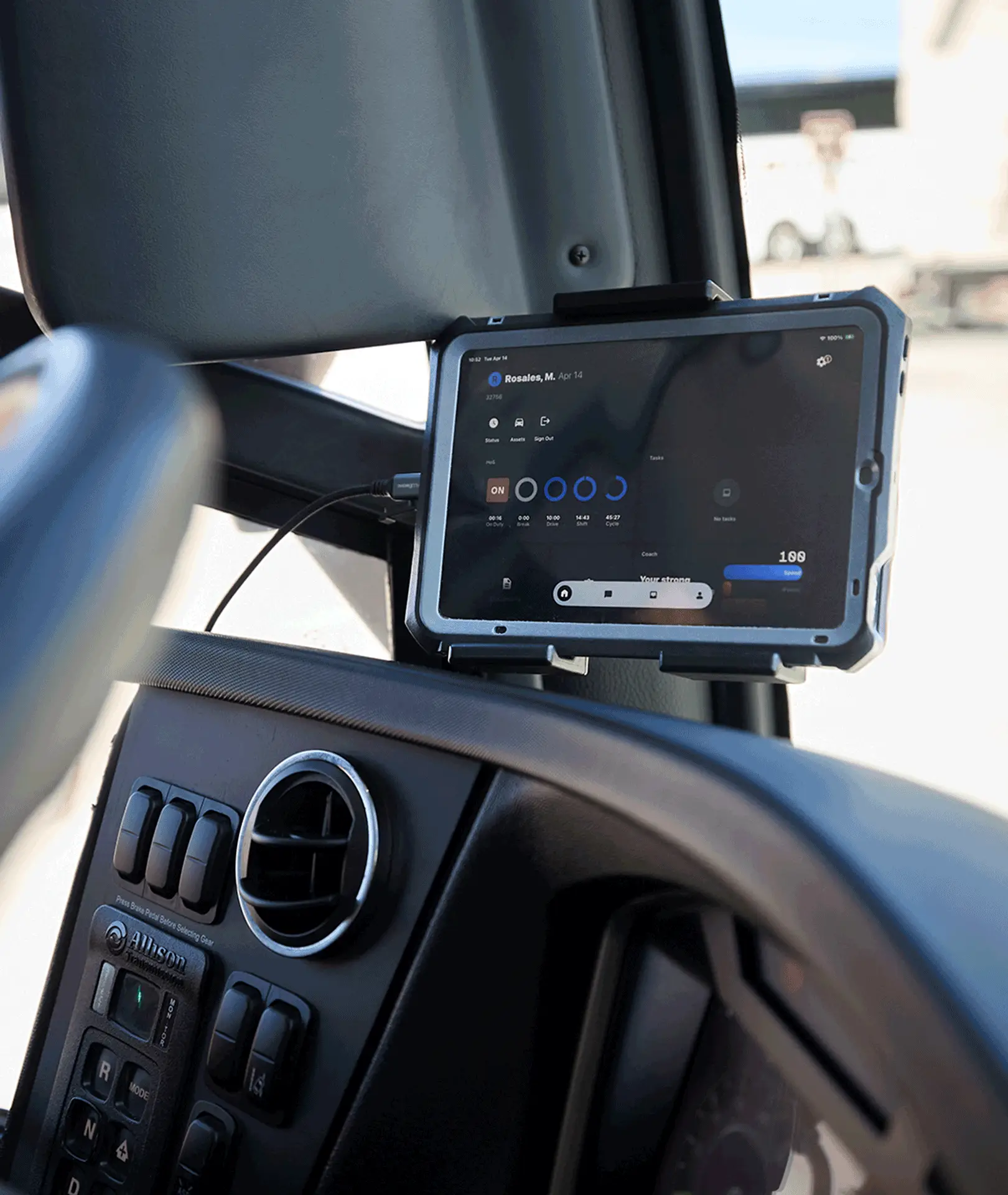 Electronic display mounted beside a motorcoach dashboard