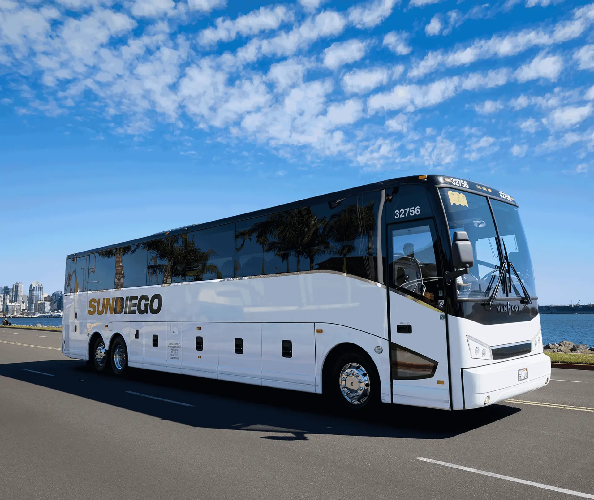 Sun Diego Charter motorcoach at the waterfront under a blue sky