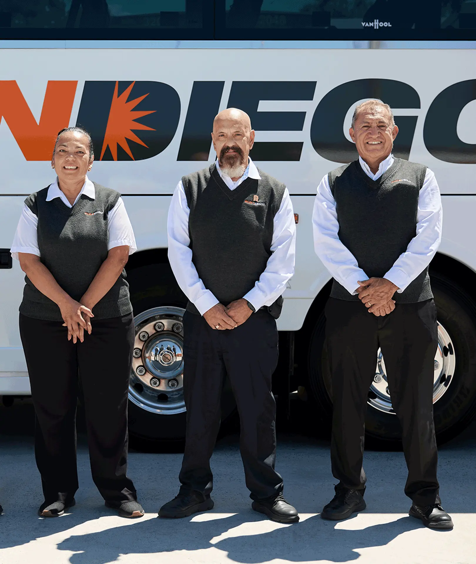Uniformed Sun Diego Charter team members standing beside a motorcoach