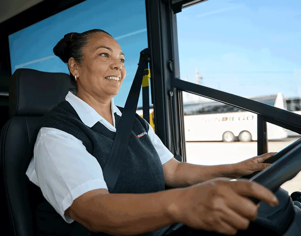 Smiling Sun Diego Charter driver seated at the wheel