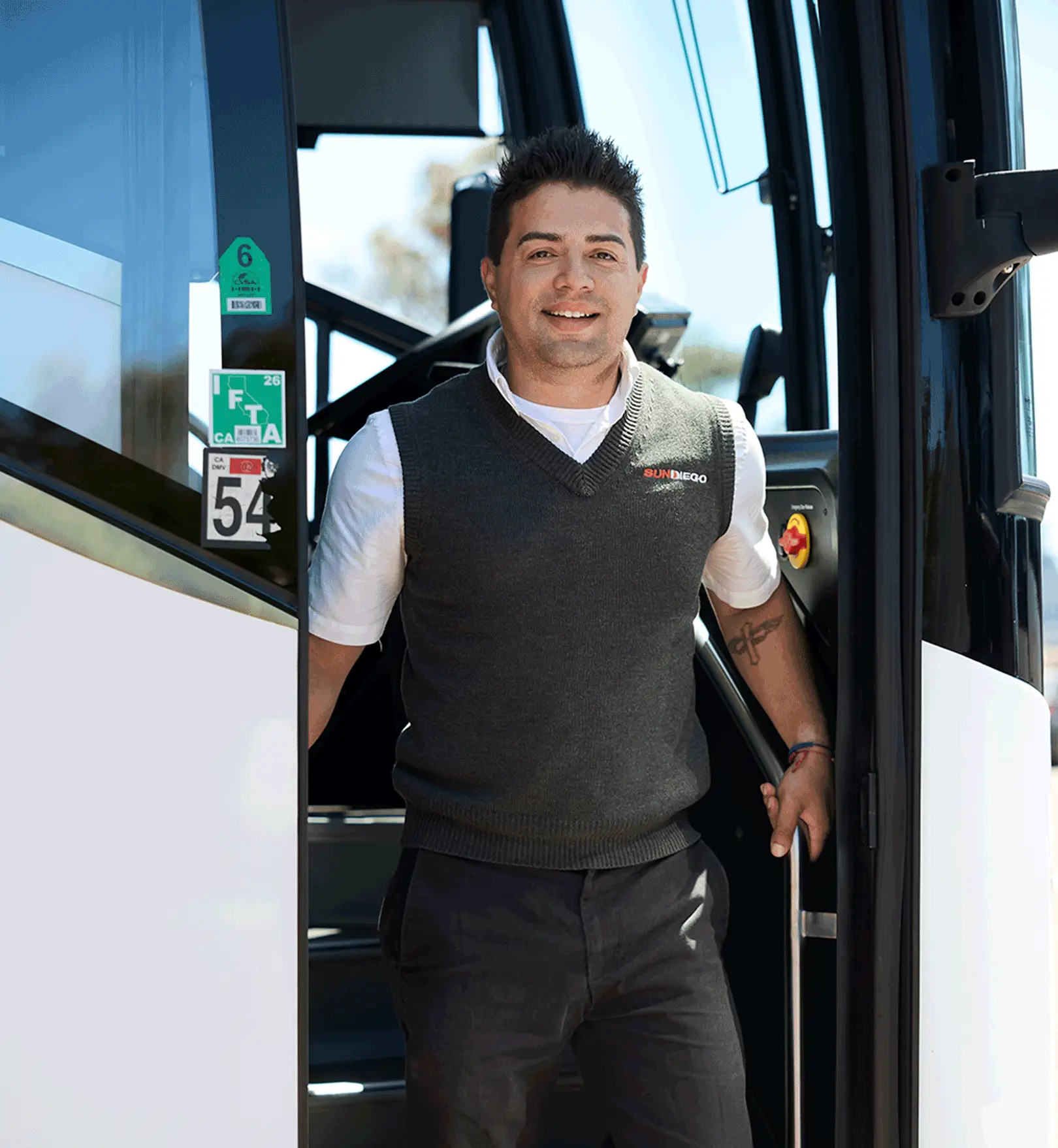 Sun Diego Charter team member standing in a motorcoach doorway