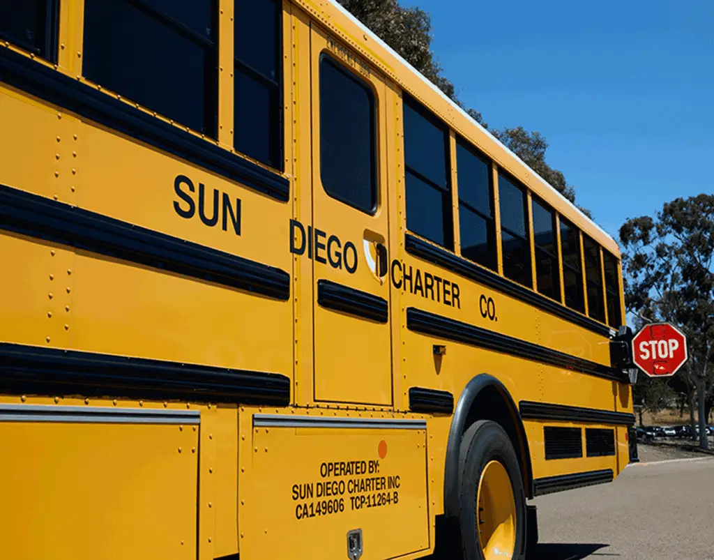 Yellow Sun Diego Charter school bus with its stop sign extended