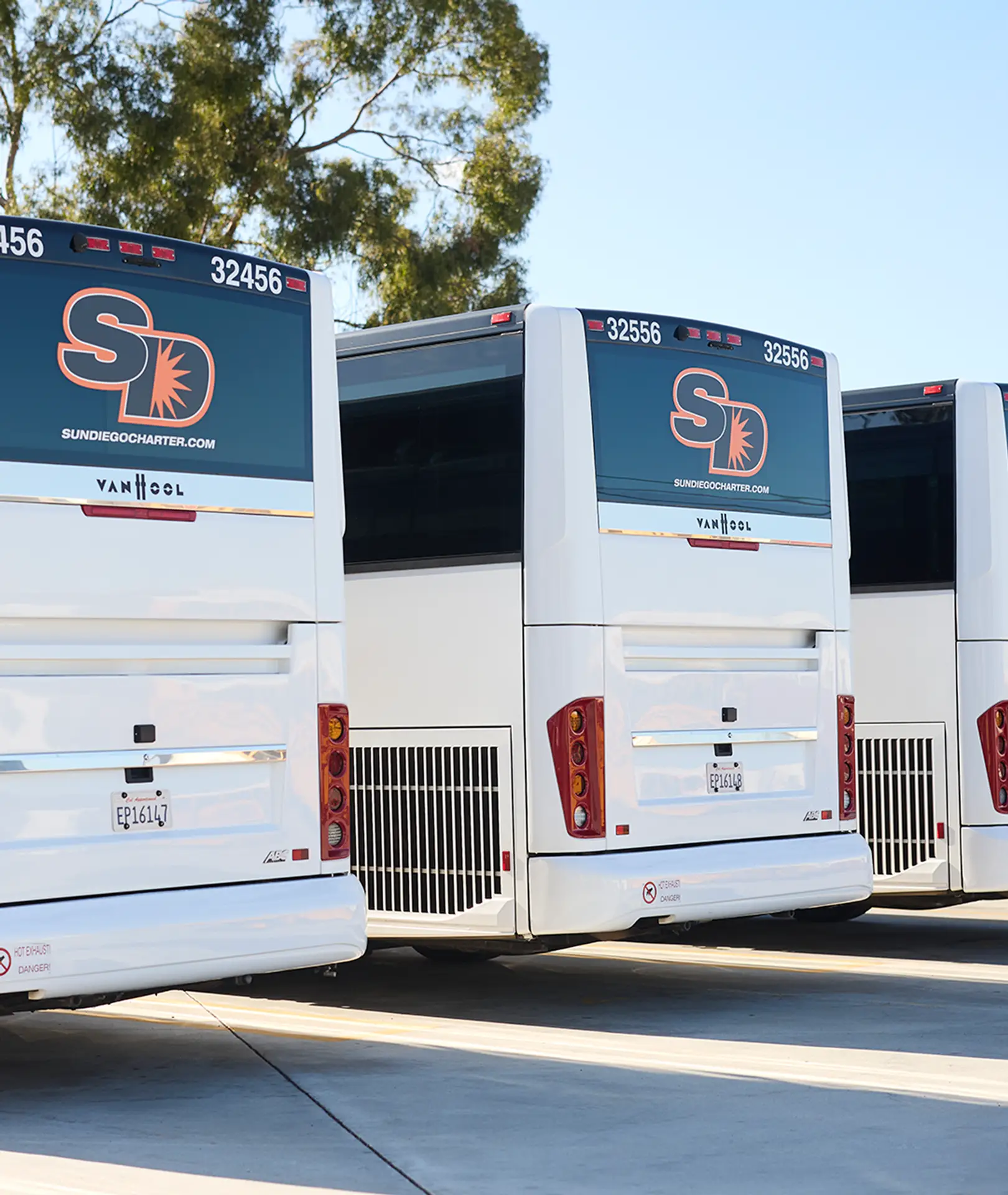 Rear view of parked Sun Diego Charter motorcoaches