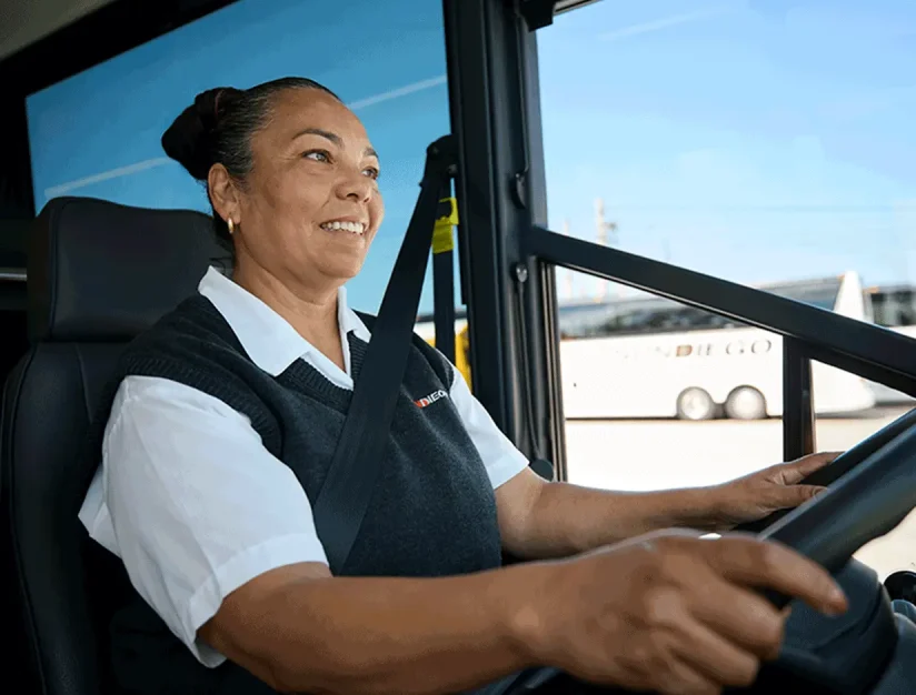 Smiling Sun Diego Charter driver seated at the wheel